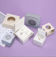 a variety of jewelry boxes on a purple background