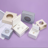 a variety of jewelry boxes on a purple background