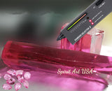 a diamond and a piece of red glass, with a diamond testing device labeled "DIAMOND SELECTOR II" placed on top of the glass.